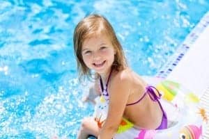Little girl with an inner tube at our Pigeon forge cabin rentals with outdoor pools.