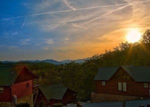 The sun setting behind cabins in the Smoky Mountains.