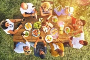 Family eating outside at a picnic table