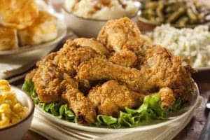 A plate of fried chicken surrounded by Southern side dishes.