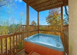 A hout tub on the deck of a Smoky Mountain cabin rental.