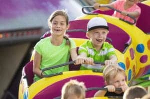 Kids riding a roller coaster.