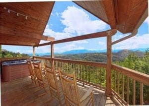 Rocking chairs on the deck of a Gatlinburg cabin with a view.