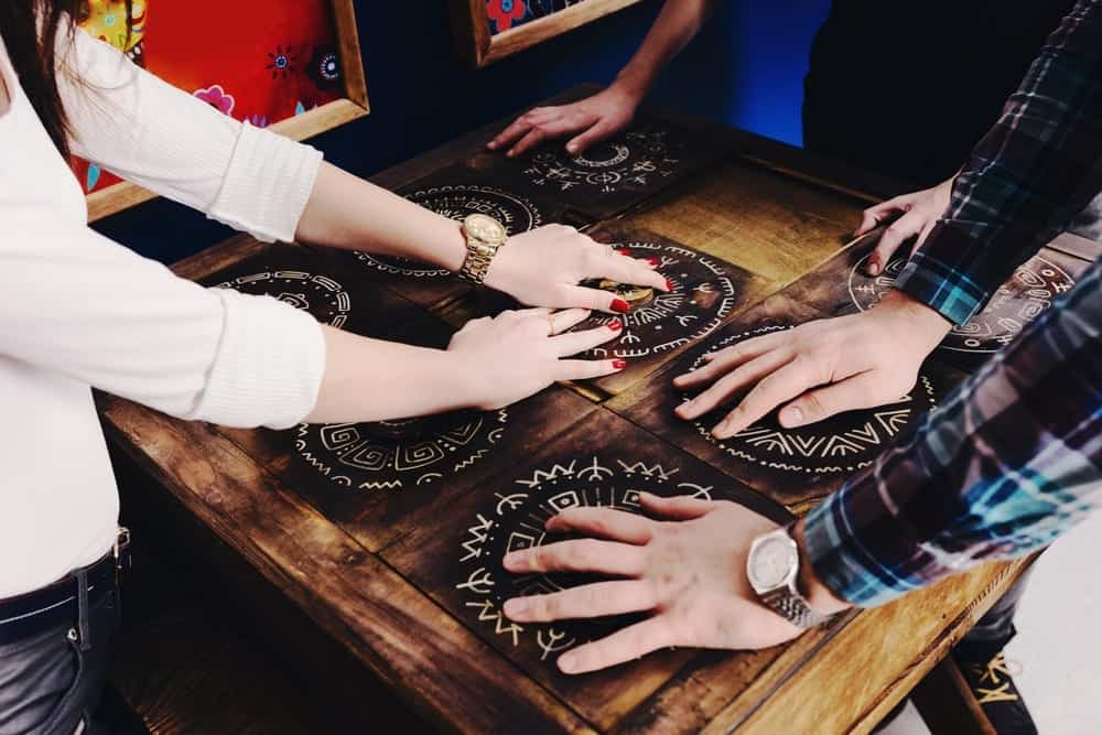 hands moving pieces on board in escape game in Pigeon Forge TN