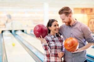 smiling couple bowling together