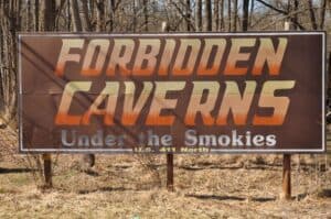 The Forbidden Caverns sign welcomes guests to a unique cave tour.