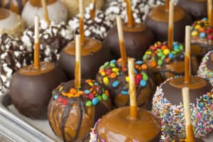 display of caramel apples with toppings