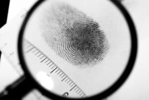 fingerprint on paper under magnifying glass